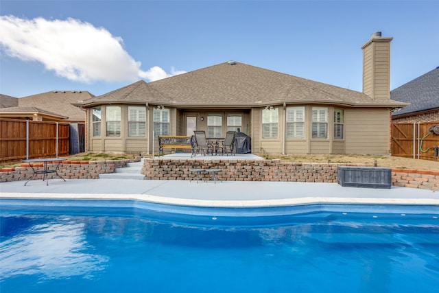 view of swimming pool featuring a patio and grilling area