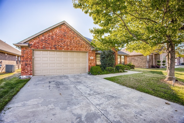 view of front of house with central AC, a garage, and a front lawn