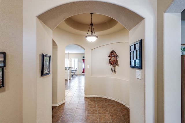 hall with tile patterned floors