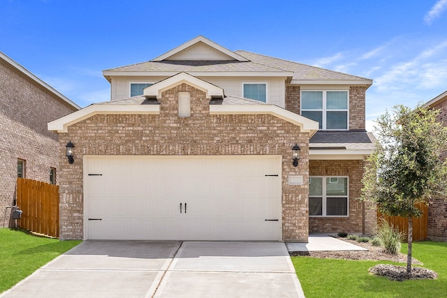 view of property with a front yard and a garage