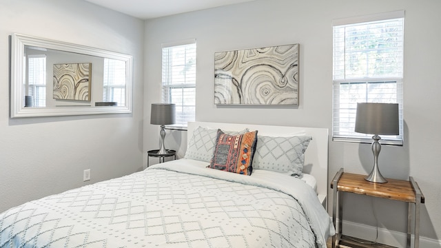 bedroom featuring multiple windows and hardwood / wood-style floors