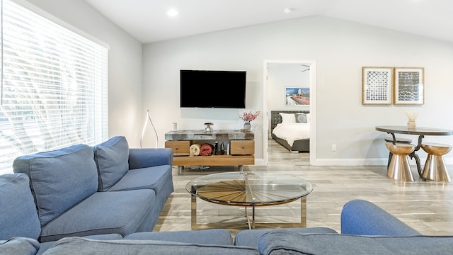 living room with lofted ceiling and light hardwood / wood-style floors