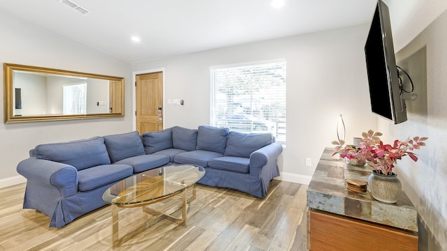 living room with lofted ceiling and hardwood / wood-style flooring