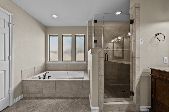 bathroom featuring vanity, tile patterned floors, and separate shower and tub