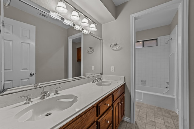 bathroom with vanity and tiled shower / bath combo