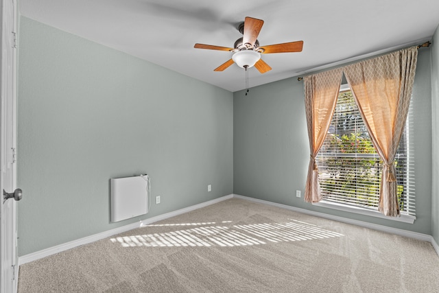 carpeted spare room with ceiling fan