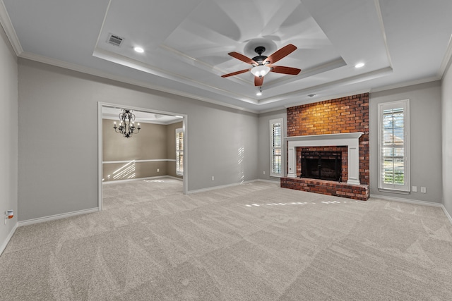 unfurnished living room featuring light carpet, ornamental molding, and a tray ceiling