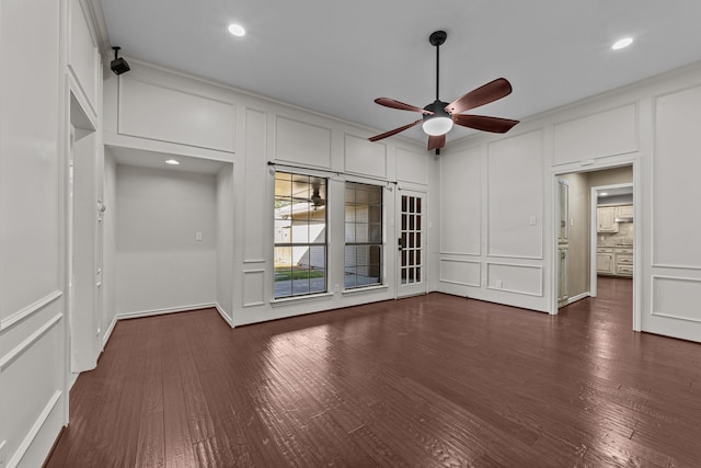 empty room featuring crown molding, ceiling fan, and dark hardwood / wood-style flooring