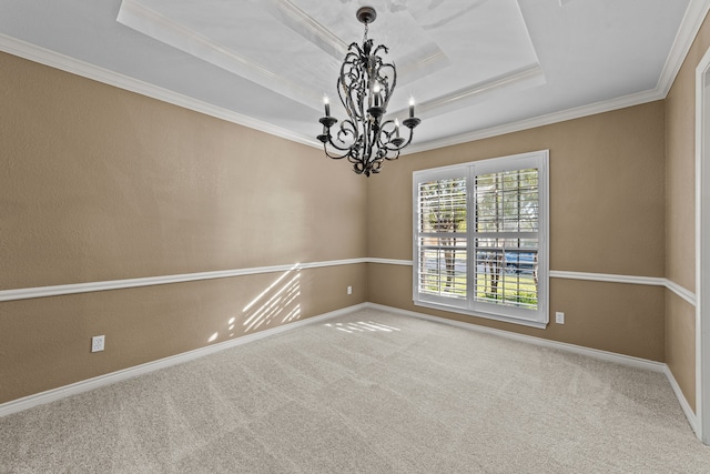 unfurnished room featuring crown molding, carpet flooring, a notable chandelier, and a tray ceiling