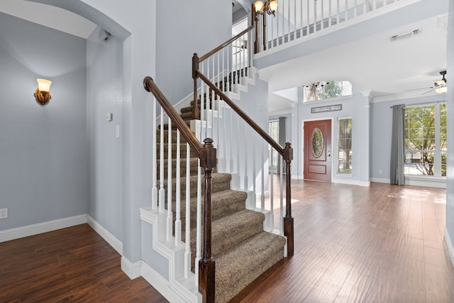 foyer featuring dark wood-type flooring and a towering ceiling