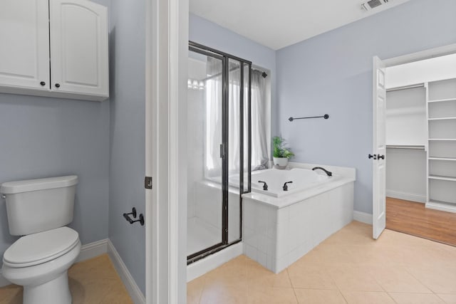 full bathroom with visible vents, a stall shower, toilet, a bath, and tile patterned floors