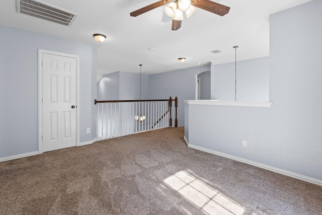 empty room with baseboards, visible vents, a ceiling fan, and carpet floors