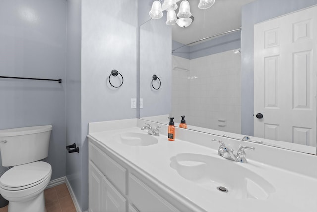 bathroom with toilet, tile patterned flooring, a sink, and double vanity