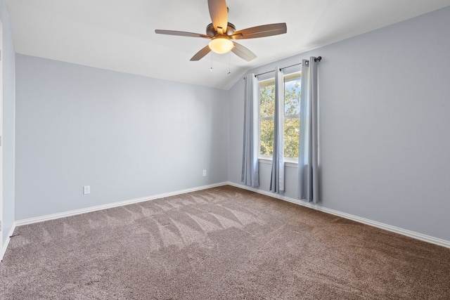 carpeted empty room featuring lofted ceiling and ceiling fan