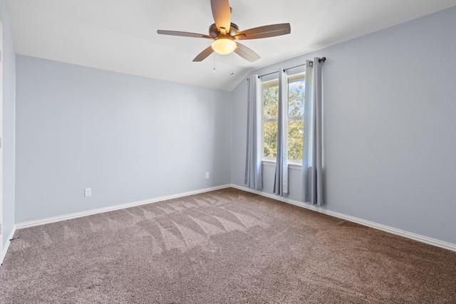carpeted spare room featuring ceiling fan, lofted ceiling, and baseboards
