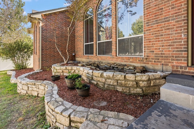 view of side of property featuring brick siding