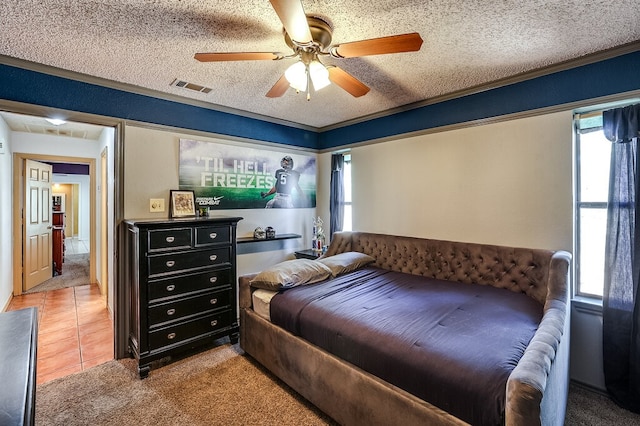 bedroom featuring ceiling fan, carpet flooring, and a textured ceiling