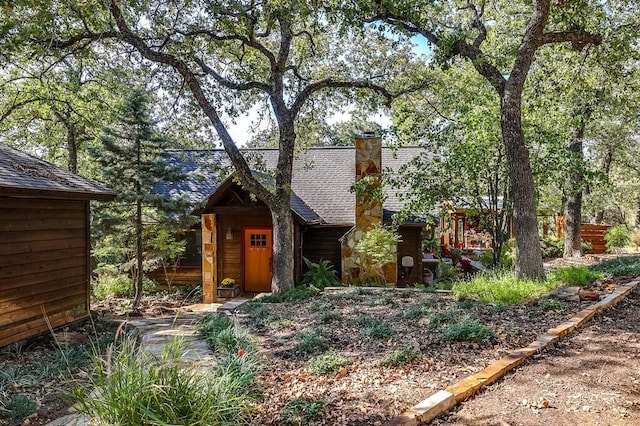 6040 Casey Ct, Fort Worth, TX 76140 - exterior space with a shingled roof, an outbuilding, and a chimney