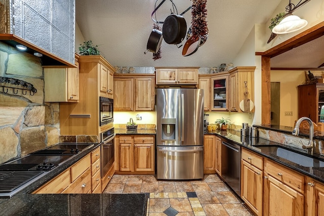 kitchen with sink, black appliances, vaulted ceiling, pendant lighting, and a textured ceiling