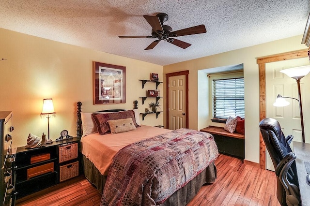 6040 Casey Ct, Fort Worth, TX 76140 - bedroom featuring wood-type flooring, a textured ceiling, and ceiling fan