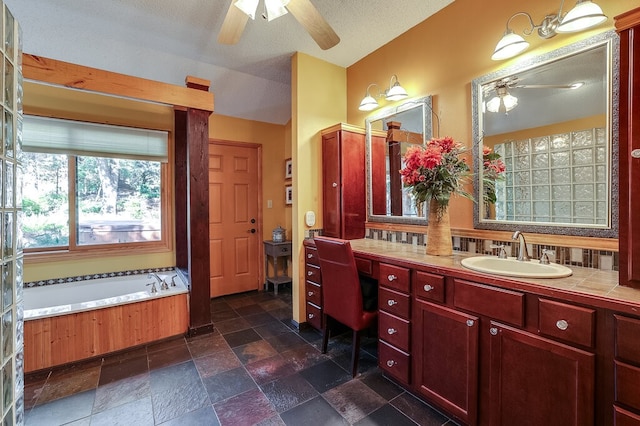 bathroom with vanity, ceiling fan, a textured ceiling, and a washtub