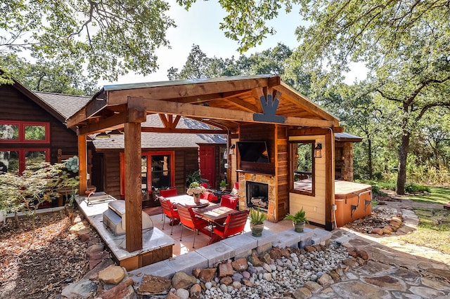 view of patio / terrace featuring an outdoor living space with a fireplace