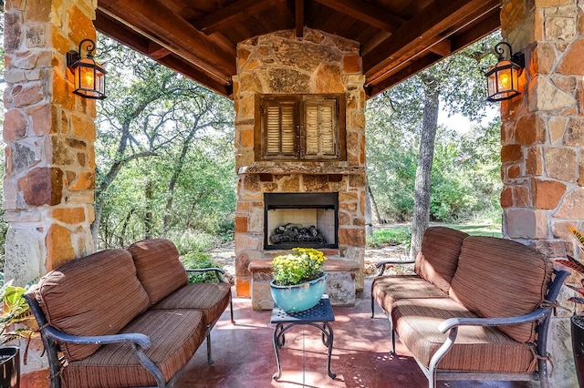 view of patio with an outdoor living space with a fireplace