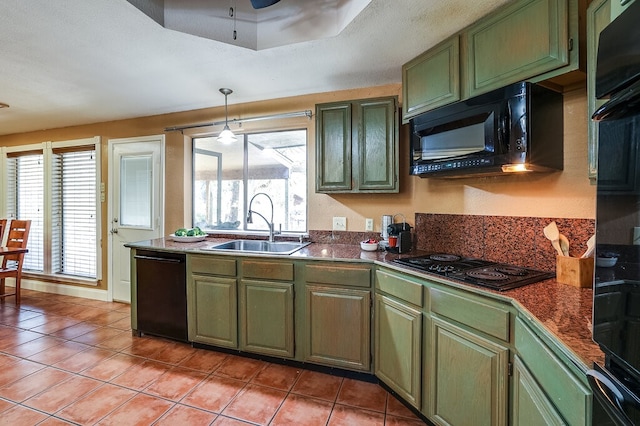 kitchen featuring a healthy amount of sunlight, black appliances, sink, and light tile patterned floors