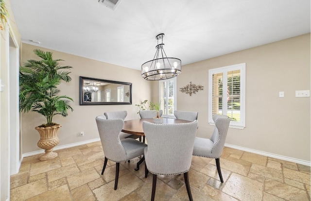 dining area featuring a notable chandelier