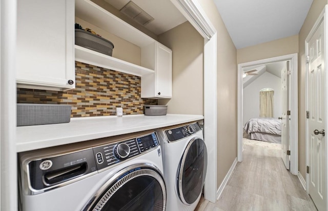 laundry area with separate washer and dryer, light wood-type flooring, and ceiling fan