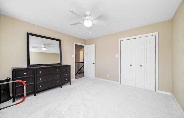 carpeted bedroom with a closet and ceiling fan