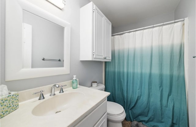 bathroom featuring vanity, toilet, and curtained shower