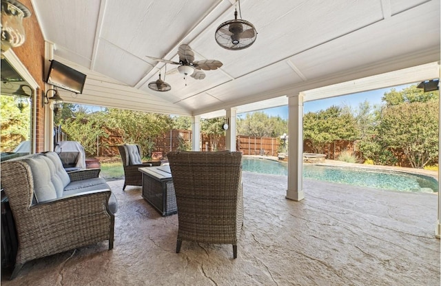 view of patio / terrace with a fenced in pool and ceiling fan