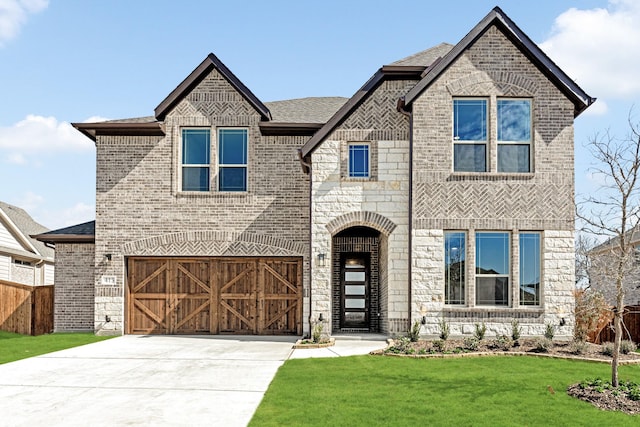 french country style house featuring driveway, stone siding, a front yard, and brick siding