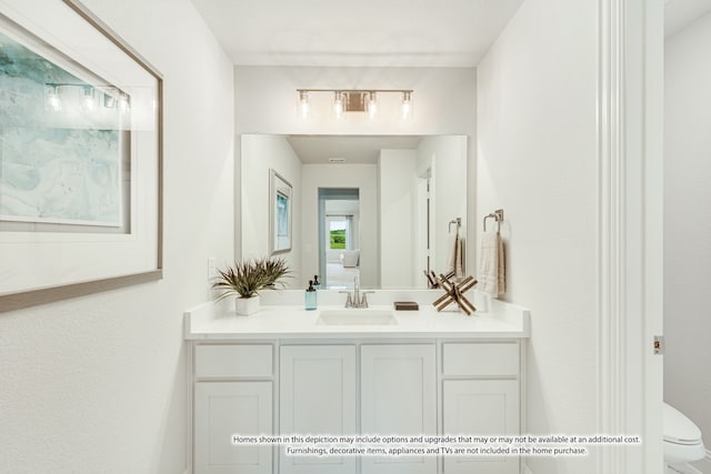 bathroom featuring toilet and vanity