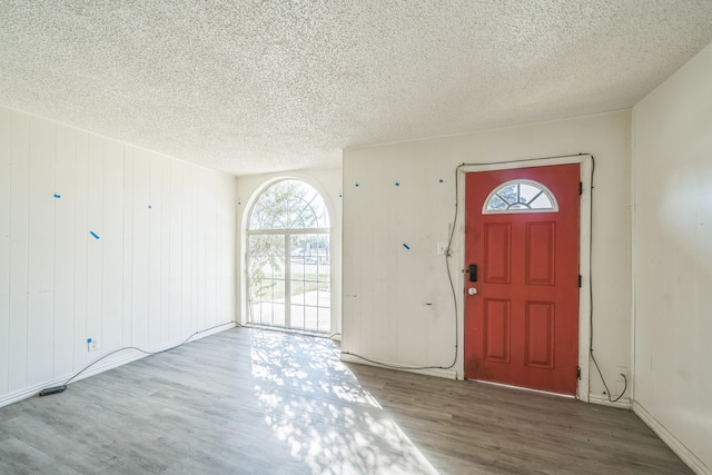 foyer entrance featuring a textured ceiling and hardwood / wood-style flooring