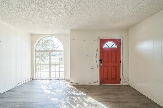 foyer entrance featuring hardwood / wood-style floors and a textured ceiling