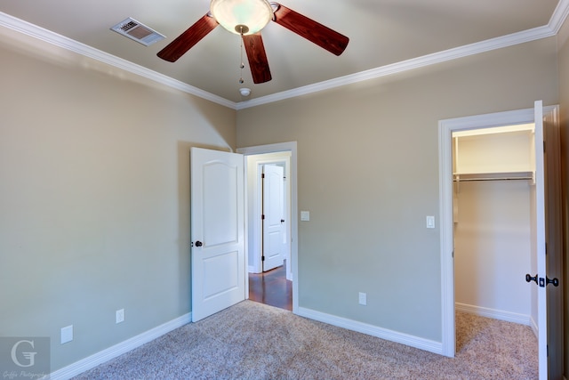 unfurnished bedroom with a closet, ceiling fan, light carpet, and ornamental molding