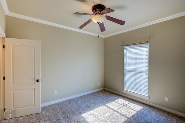 carpeted empty room with ornamental molding and ceiling fan