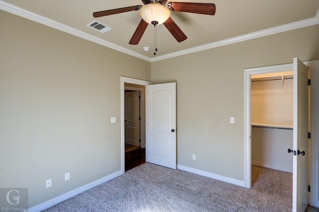 unfurnished bedroom featuring light carpet, a closet, ornamental molding, and ceiling fan