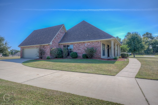 view of front of property featuring a garage and a front lawn