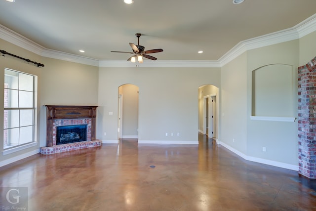 unfurnished living room featuring crown molding, a brick fireplace, plenty of natural light, and ceiling fan