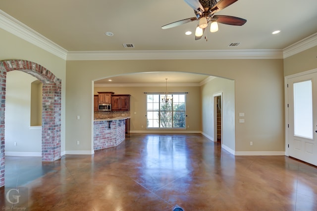 unfurnished living room with crown molding and ceiling fan with notable chandelier