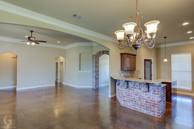 kitchen featuring kitchen peninsula, a breakfast bar, crown molding, pendant lighting, and tasteful backsplash