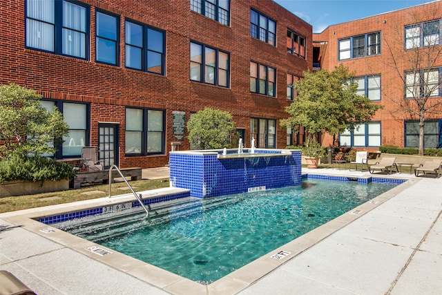 view of swimming pool featuring pool water feature