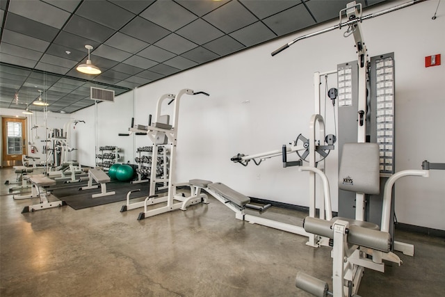 gym with a paneled ceiling