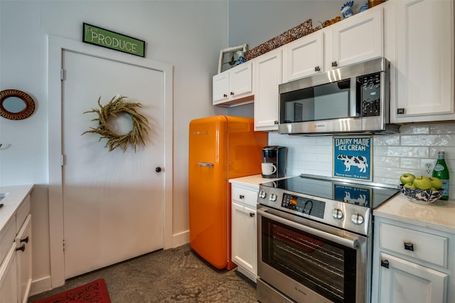 kitchen featuring white cabinetry, decorative backsplash, and stainless steel appliances