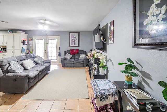 living room featuring french doors and light tile patterned flooring