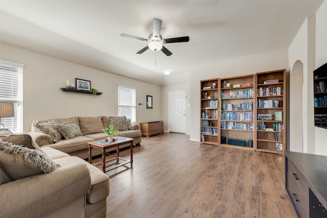 living room featuring ceiling fan and wood-type flooring