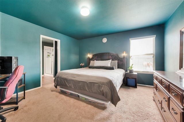 bedroom with light carpet and a textured ceiling